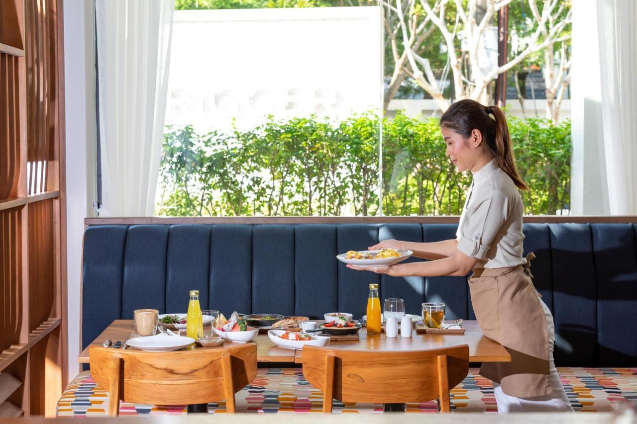 Outrigger Surin Beach Resort - Sha Extra Plus ภายนอก รูปภาพ A Thai waitress serving food
